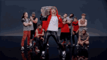a woman in a red hoodie is holding a boombox
