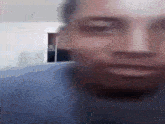 a blurry picture of a man 's face with his eyes closed and his mouth open .
