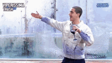 a man holding a glass of wine in front of a window that says vetrate weisse on it