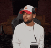 a man wearing headphones and a hat that says jets