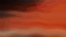 a blurry picture of a person 's face with a red and black background