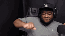 a man wearing headphones and a hat with xb ox on it