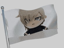 a stuffed animal with a cat ear and a black shirt is on a flag