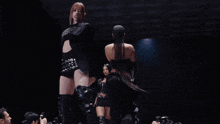 a woman in a black outfit with a belt that says ' 00 ' on it
