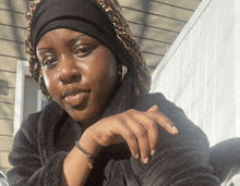 a woman wearing a leopard print hat and a black sweater