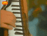 a person is playing an accordion with gmc written on the bottom