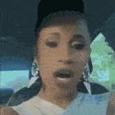 a close up of a woman 's face in a car with her mouth open