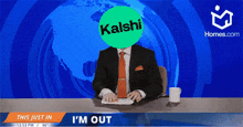 a man in a suit and tie is sitting at a desk with a kaishi logo in front of him