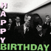 a man in a suit and tie is covering his face with his hat and the words happy birthday are above him