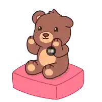 a brown teddy bear is sitting on a pink pillow with a play button on it
