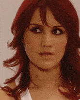 a close up of a woman with red hair