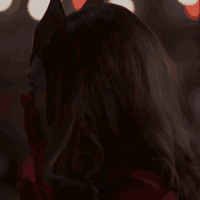 a close up of a woman wearing a red helmet
