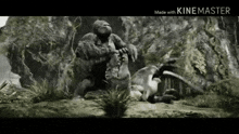 king kong is fighting a dinosaur in the jungle .