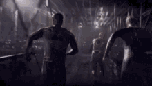 a group of people are running in a dark room holding hands .