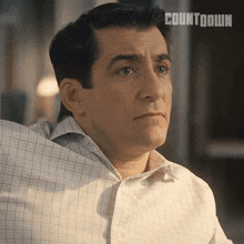 a man in a plaid shirt has the word countdown on the bottom