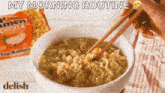 a person is eating ramen with chopsticks from a bowl .
