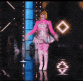 a woman in a pink dress and boots is dancing