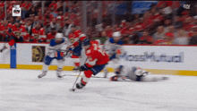 a hockey game is being played in front of a wall that says ' sn ' on it