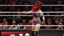 a woman in a wrestling ring with the word monday on the bottom right