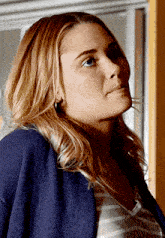 a woman wearing a striped shirt and a blue jacket