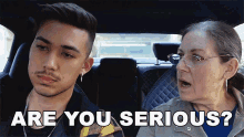 a man and a woman are sitting in a car and the man asks the woman are you serious