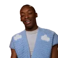 a man wearing a blue sweater with white clouds on the front