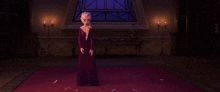 a woman in a purple dress is standing in a room