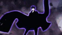 a man in a suit is standing in the dark with a purple glow behind him .