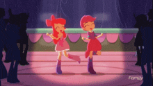 two cartoon girls are dancing on a stage with the word family in the corner