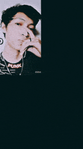 a man wearing a black shirt that says punk on it