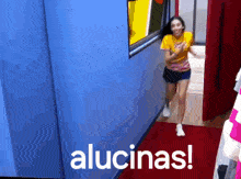 a woman running in a hallway with the words alucinas written on the bottom