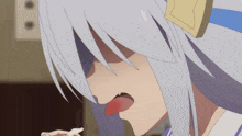 a girl with white hair is eating something with her tongue out