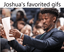 a man in a suit holds up a piece of paper with the caption " joshua 's favorite gifs " above him
