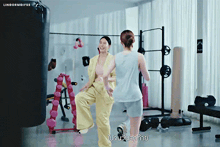 two women are dancing in a gym with lingormgifes written on the bottom of the screen