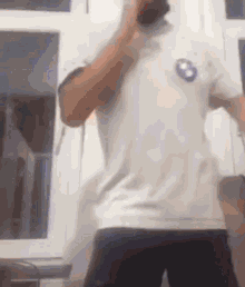 a man wearing a white shirt with a bmw logo on the front