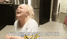 a woman is crying and saying `` thank you so much '' while sitting on the floor .