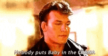 a man in a leather jacket is talking to another man and says `` nobody puts baby in the room '' .