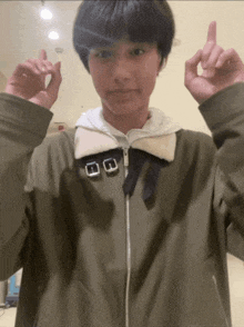 a person wearing a jacket with two buckles on the collar
