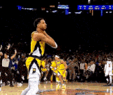 a basketball player in a yellow jersey with the number 2 on the back