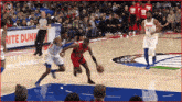a basketball player wearing a number 21 jersey dribbles the ball