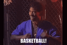 a man in a blue shirt says basketball in white letters