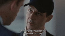 a man in a hat talks to another man in a suit