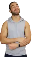 a man with his eyes closed is wearing a gray tank top