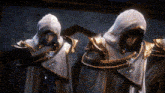 a group of people with hoods on their heads