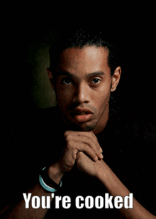 a close up of a man in a suit and tie with the words `` i 'm cooked '' written on his face .