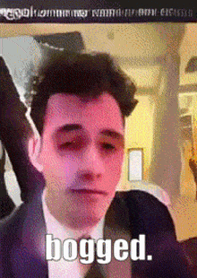 a man in a suit and tie with his eyes closed and the word bogged written on the bottom