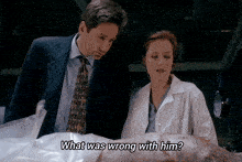 a man and a woman are looking at a dead body and the words what was wrong with him are visible