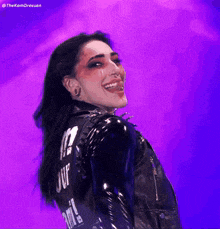 a woman is wearing a black leather jacket with the word juf on the back
