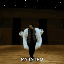 a person is spinning a white blanket on a wooden floor in a dance studio .