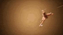 a person is flying through the air while holding a sword .